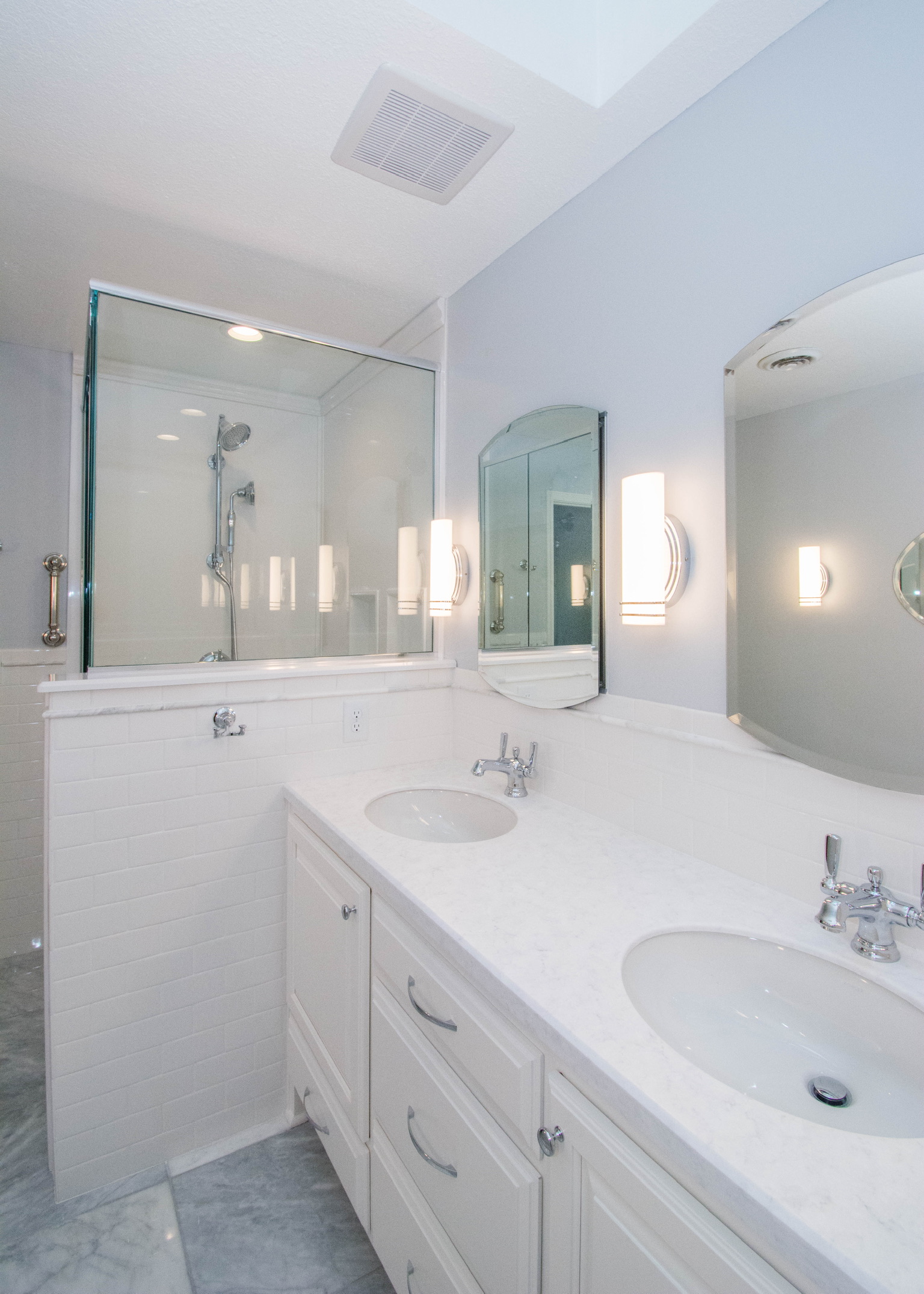 Bright white bathroom with double sink vanity